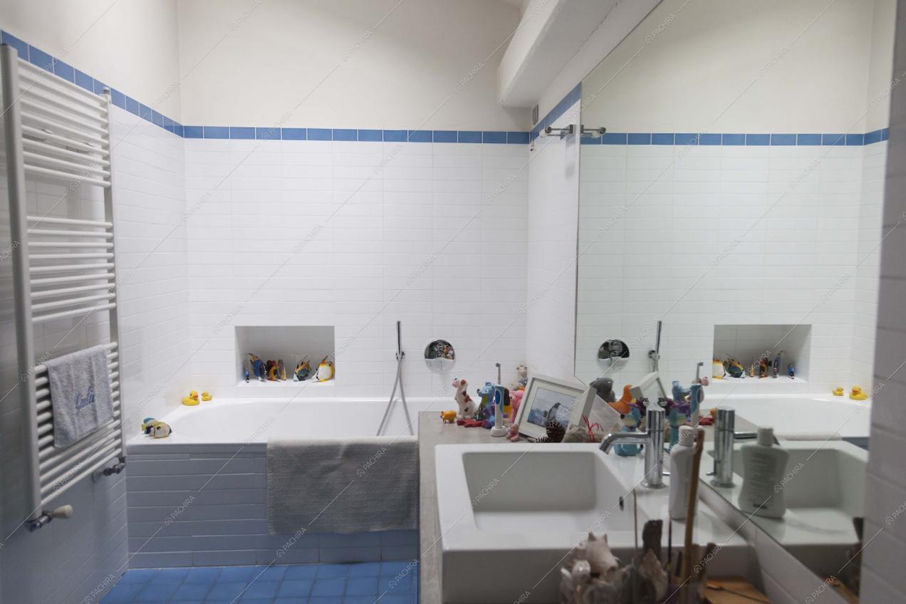 Bagno con pavimento in piastrelle più e vasca da bagno