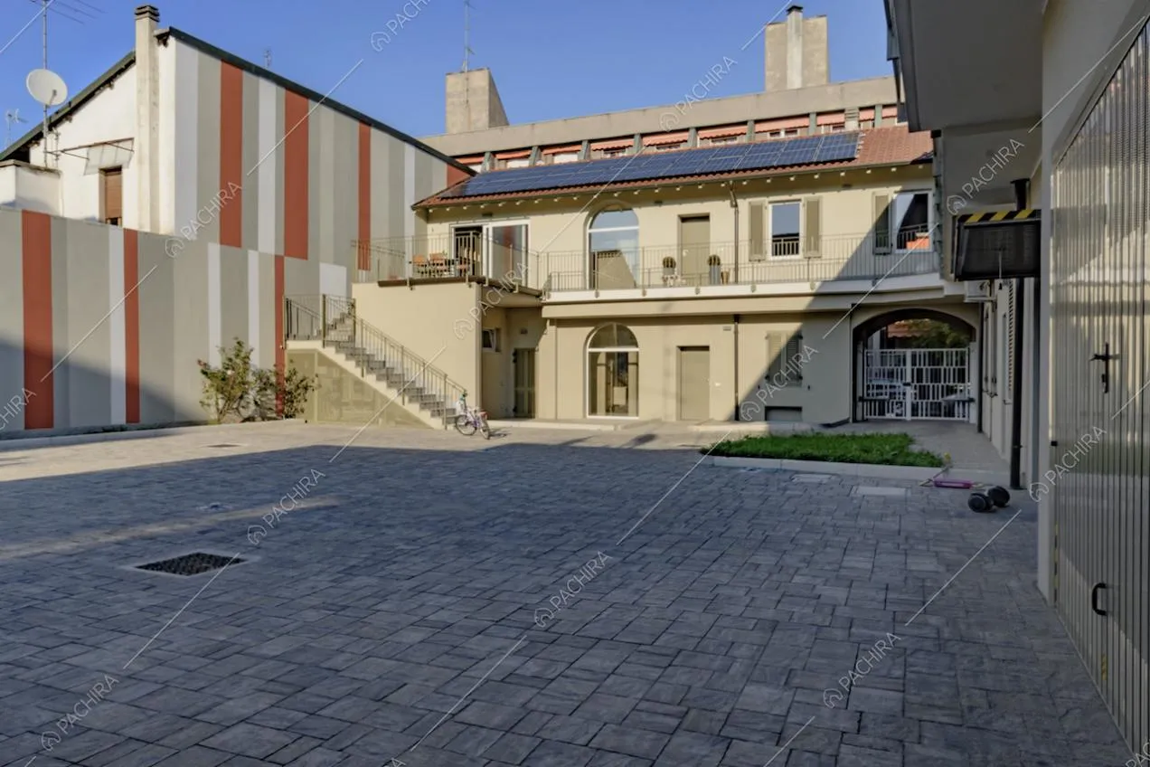 Casa di ringhiera con pavimentazione in pietra nella corte