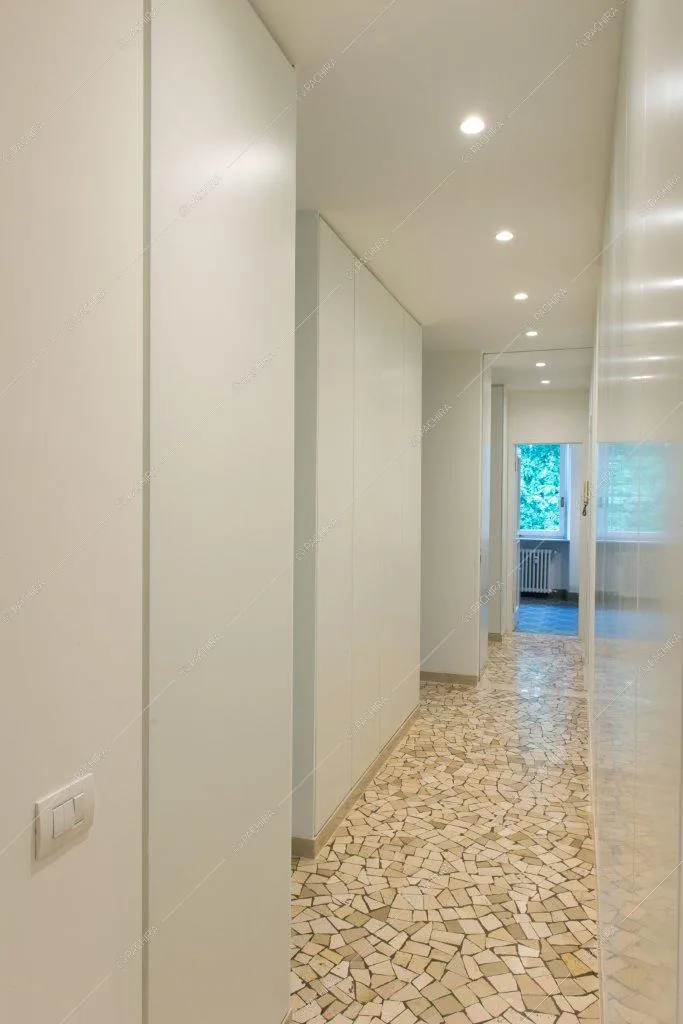 Corridoio banco con vista sul bagno e pavimento in marmo