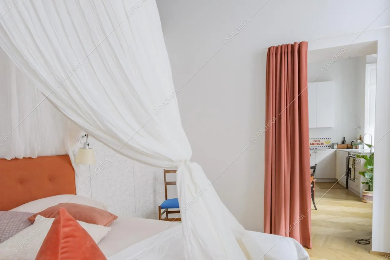 Camera con letto a baldacchino e vista sulla cucina