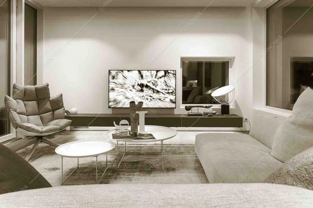 Salotto con poltrona di design, divano angolare e pavimento in parquet