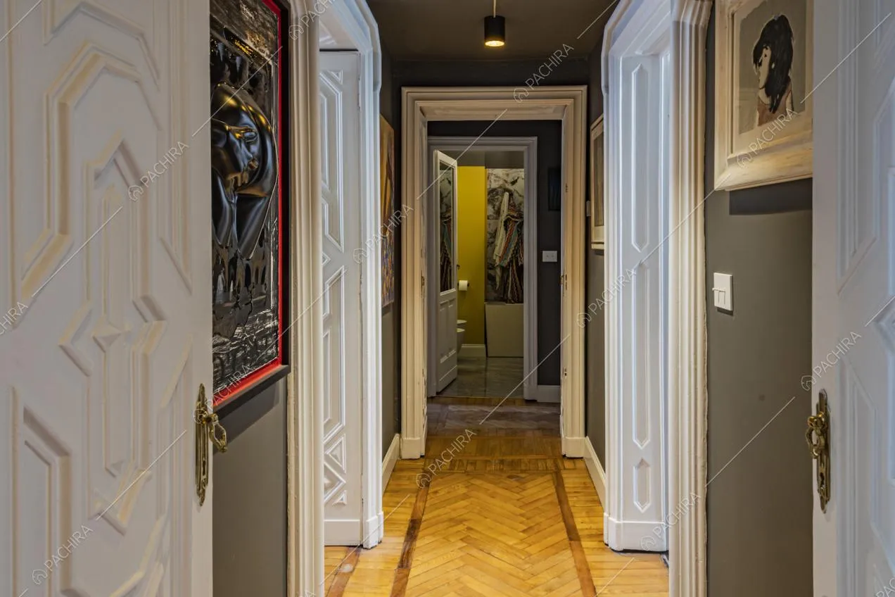 Corridoio con pavimento in parquet e porte d'epoca intarsiate