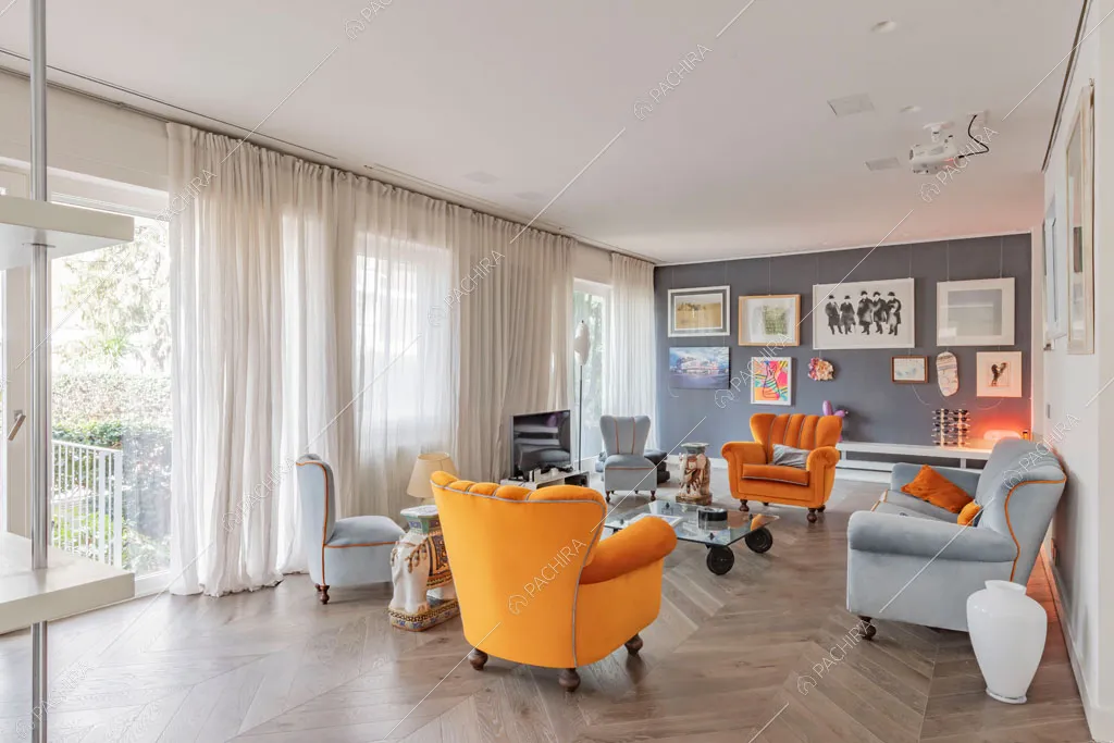 Vetrate e parete grigia nella zona living dell'appartamento Sonora, location in stile contemporaneo a Roma