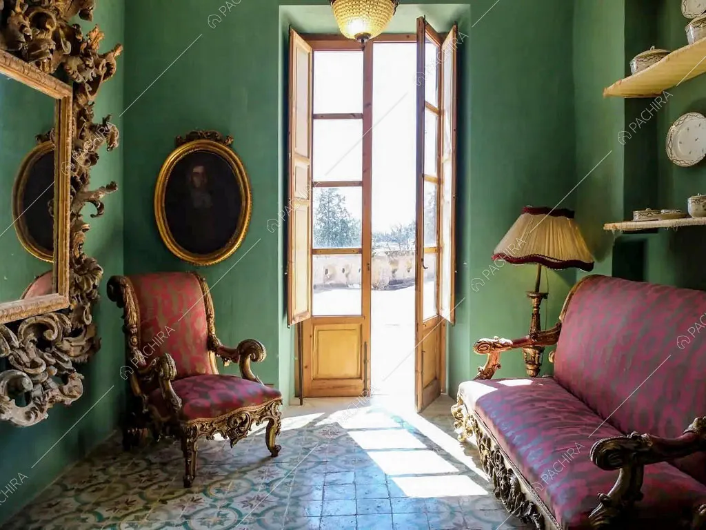 Salotto con pareti verdi della villa Tanami, location in stile classico a Palermo