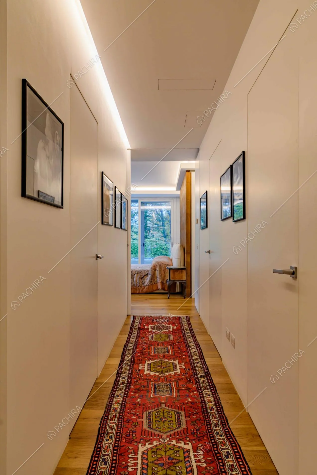 Dal corridoio dalle pareti bianche e dal pavimento in parquet vista sulla camera da letto matrimoniale