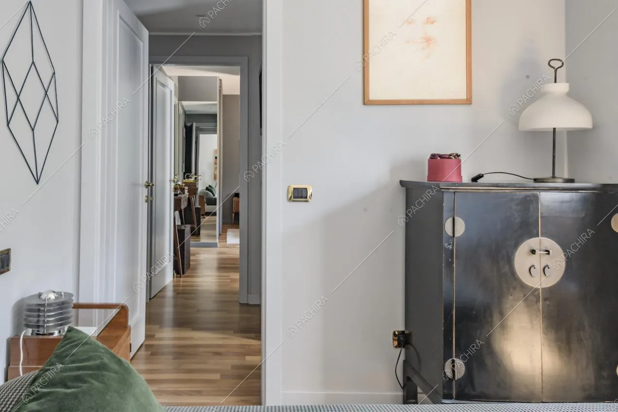 Corridoio con pavimento in parquet e porte bianche