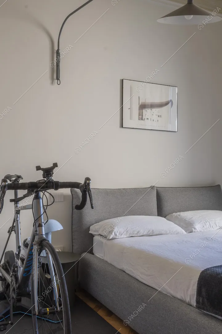 Bicicletta da corsa di fianco al letto matrimoniale