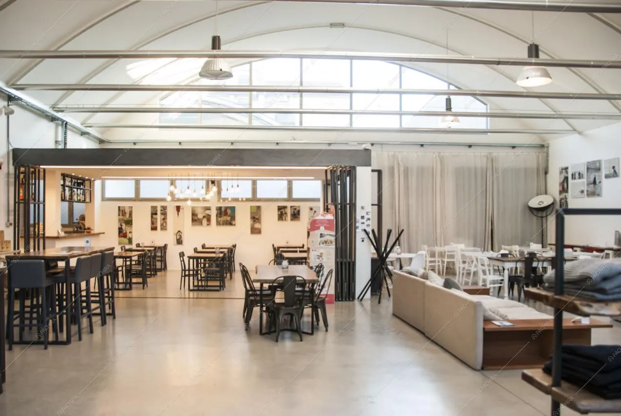 Locale con tavoli, sgabelli neri