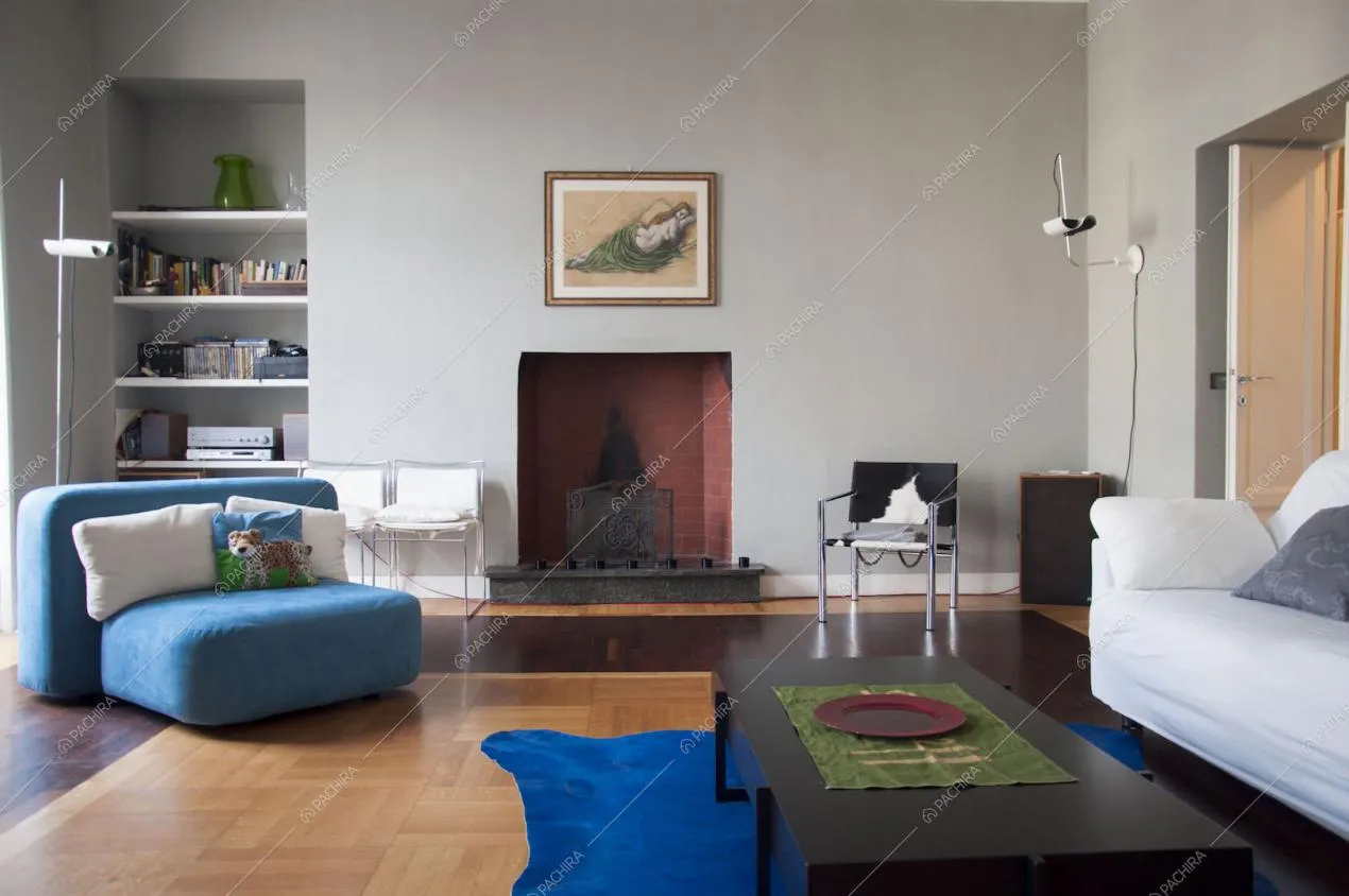 Zona living con pavimento in parquet e camino