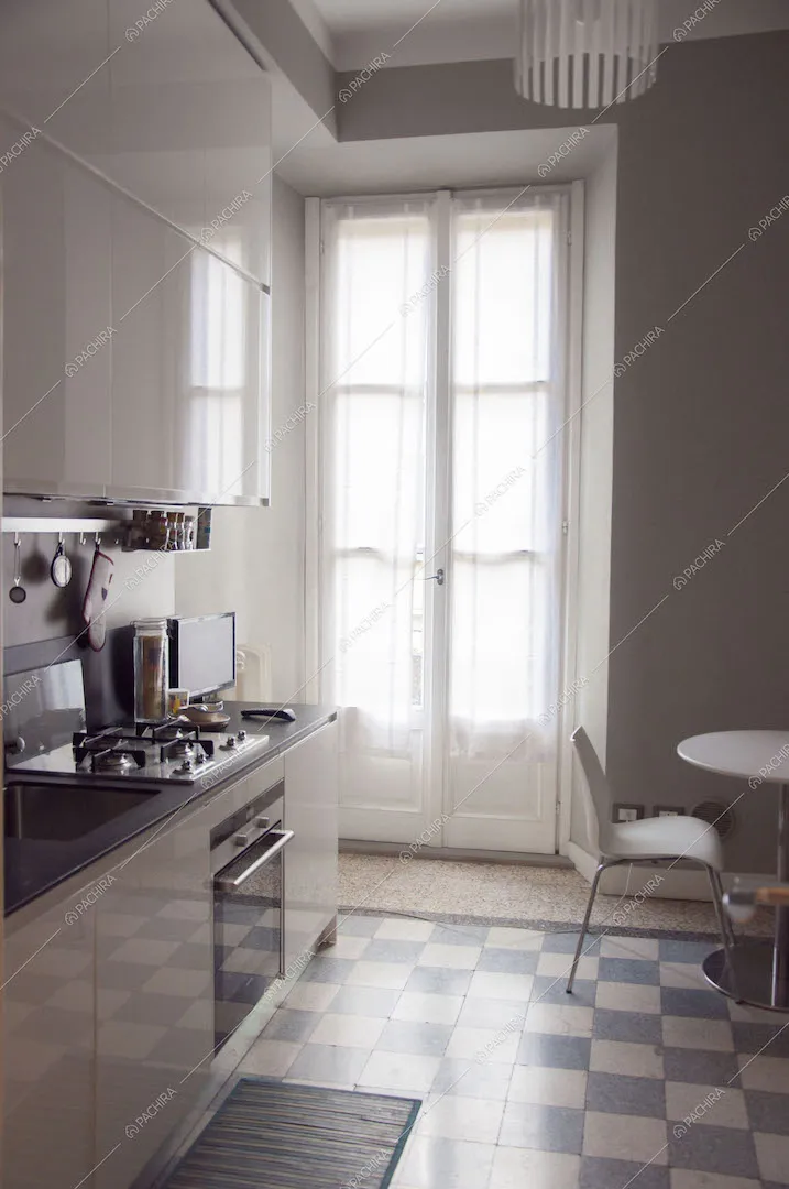 Cucina con pavimento in piastrelle, porta finestra