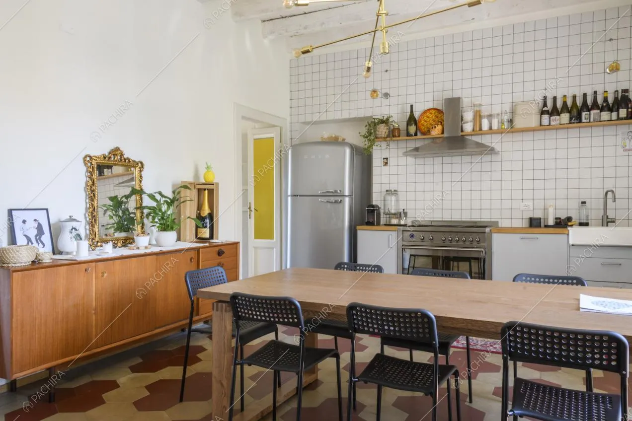 Credenza in legno nella cucina, tavolo da pranzo e frigorifero