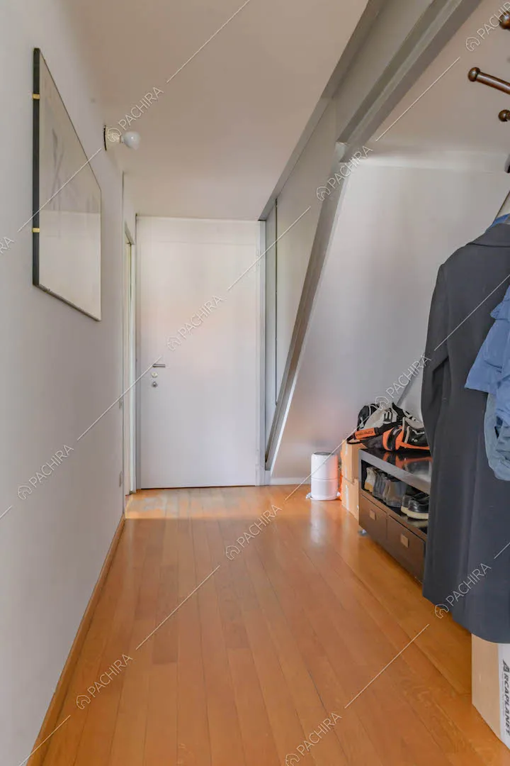 Corridoio dalle pareti bianche e con pavimento in parquet