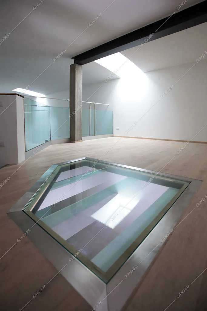 Stanza vuota con pavimento in parquet e vetrate