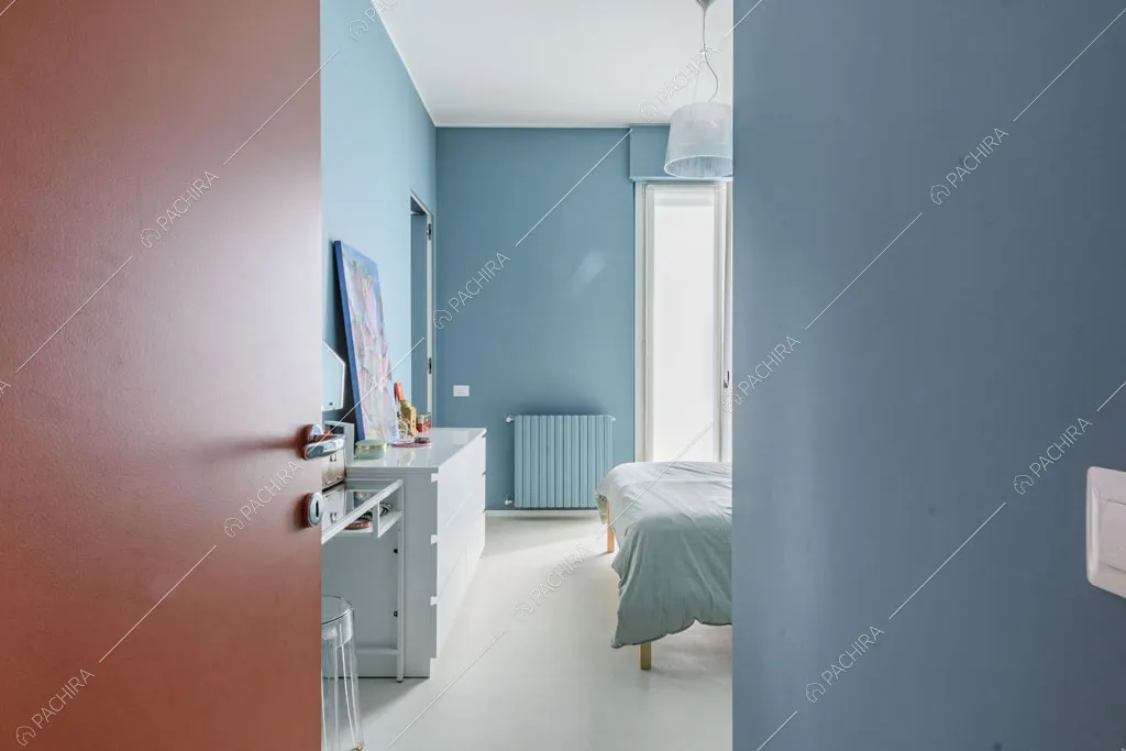 Pareti azzurre della camera da letto dell'appartamento Papagayo, location in stile contemporaneo a Milano