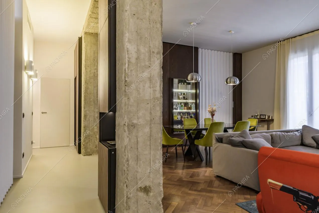Zona living con colonne in stile industriale