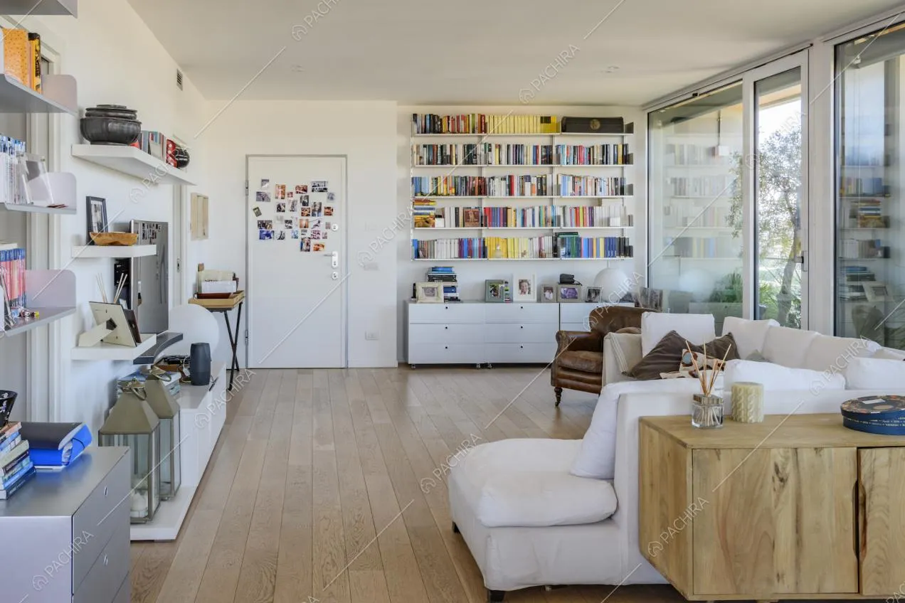 Libreria e mensole bianche nel soggiorno