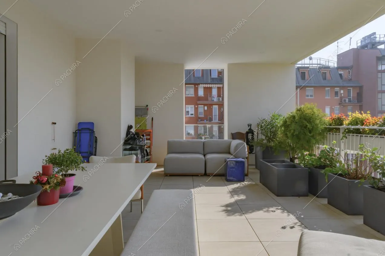 Tavolo da pranzo sulla terrazza e divani grigi da esterno