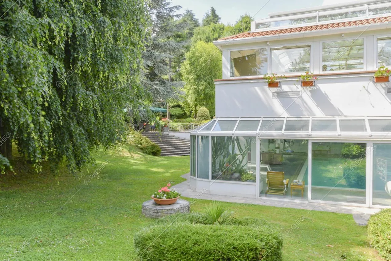 Scorcio dal giardino sulla piscina al chiuso e sulla serra