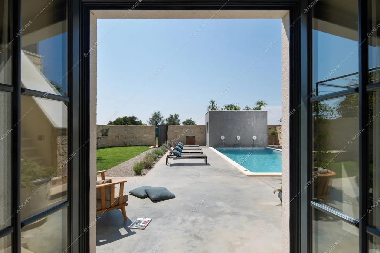Vista sulla piscina esterna e le mura di recinzione