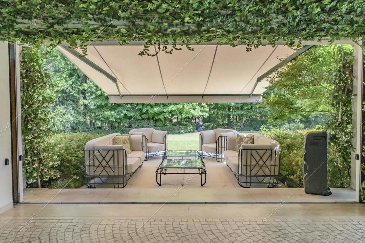 Dalla veranda vista sui divani bianchi coperti da una grande tenda bianca