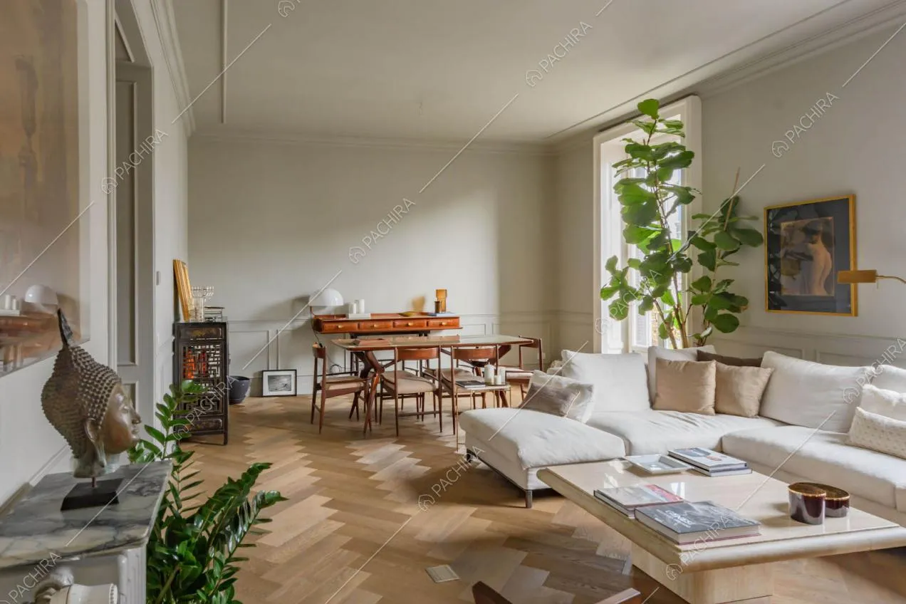 Spazioso salotto con pavimento in parquet a spina di pesce e boiserie alle pareti