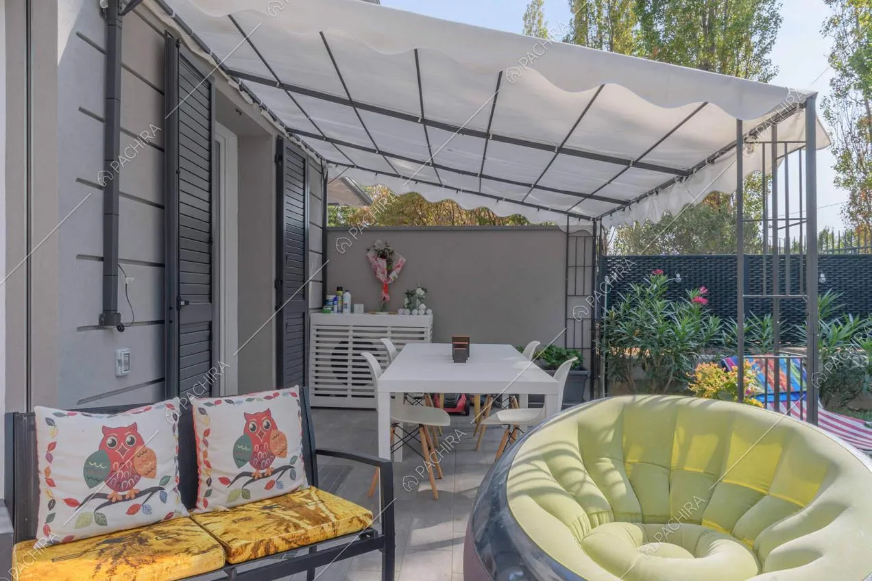 Divano e pouf nel giardino con veranda della villa