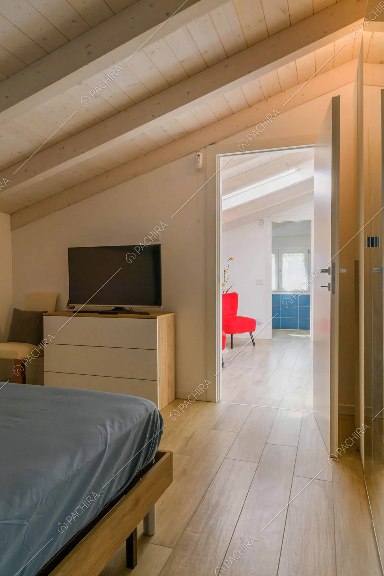 Dal letto matrimoniale della camera vista sull'atrio con poltrone rosse