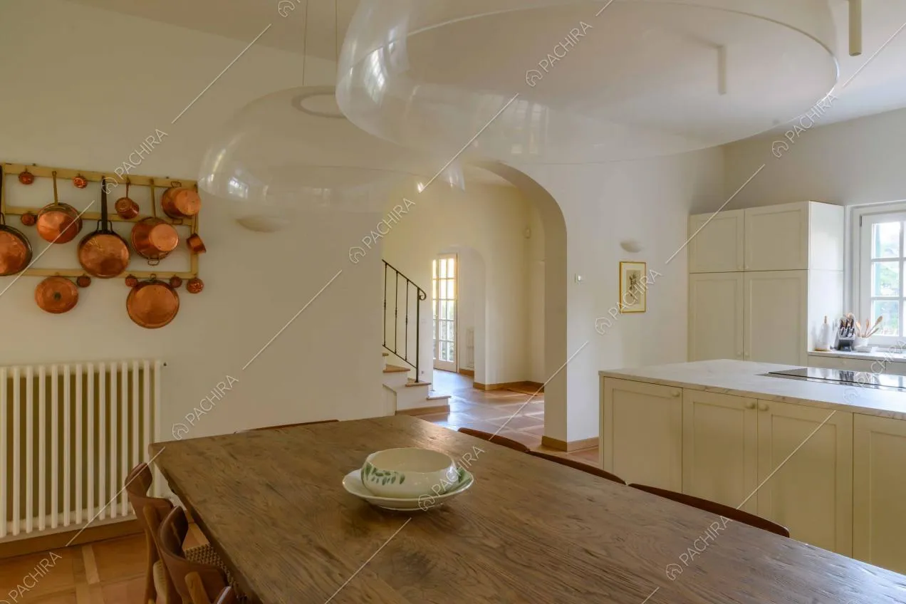 Tavolo da pranzo in legno nella cucina a isola con fornelli a induzione della Location Margherita