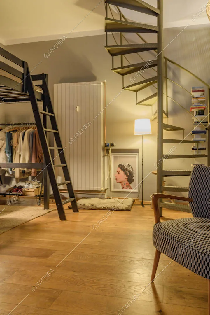 Pavimento in parquet nella camera con letto a soppalco e scala a chiocciola