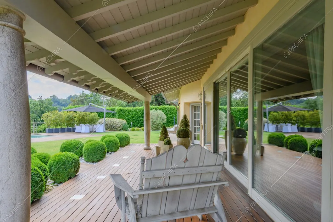 Dalla veranda con colonne doriche, vista sul giardino e sulle porte-finestre