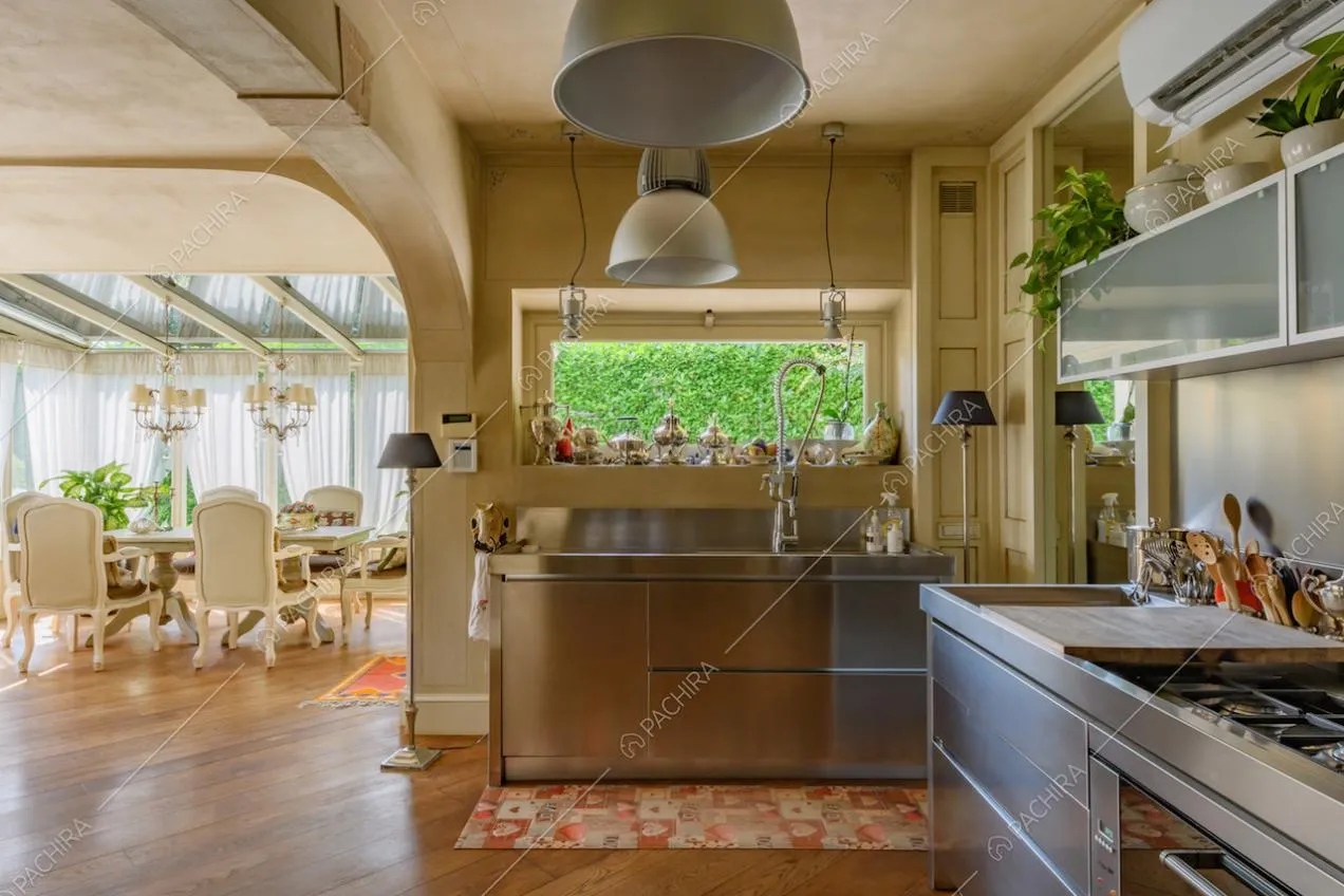 Dalla cucina a parete con fornelli a gas vista sulla tavola da pranzo