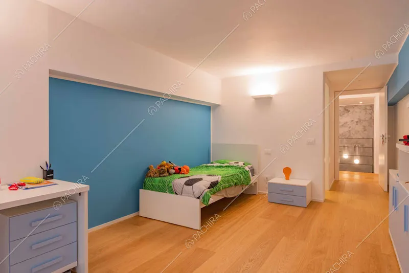 Camera da letto dei bambini con parete azzurra e scrivania
