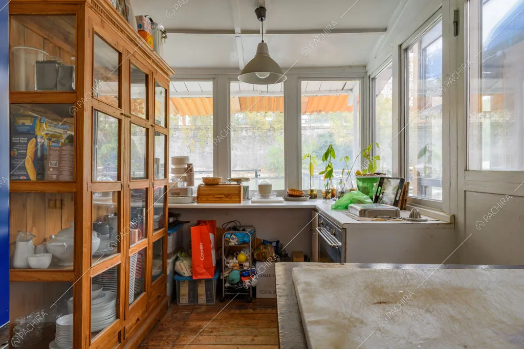 Cucina a parete con pavimento in parquet e credenza in vetro e in legno
