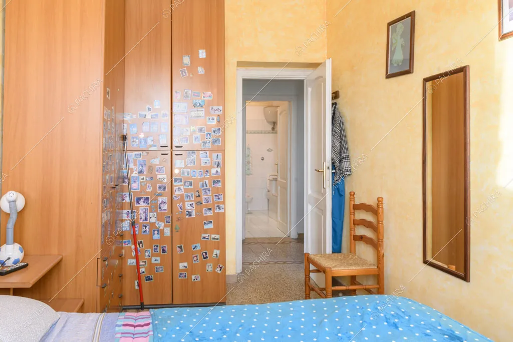 Dal letto della camera con pareti gialle vista sul bagno