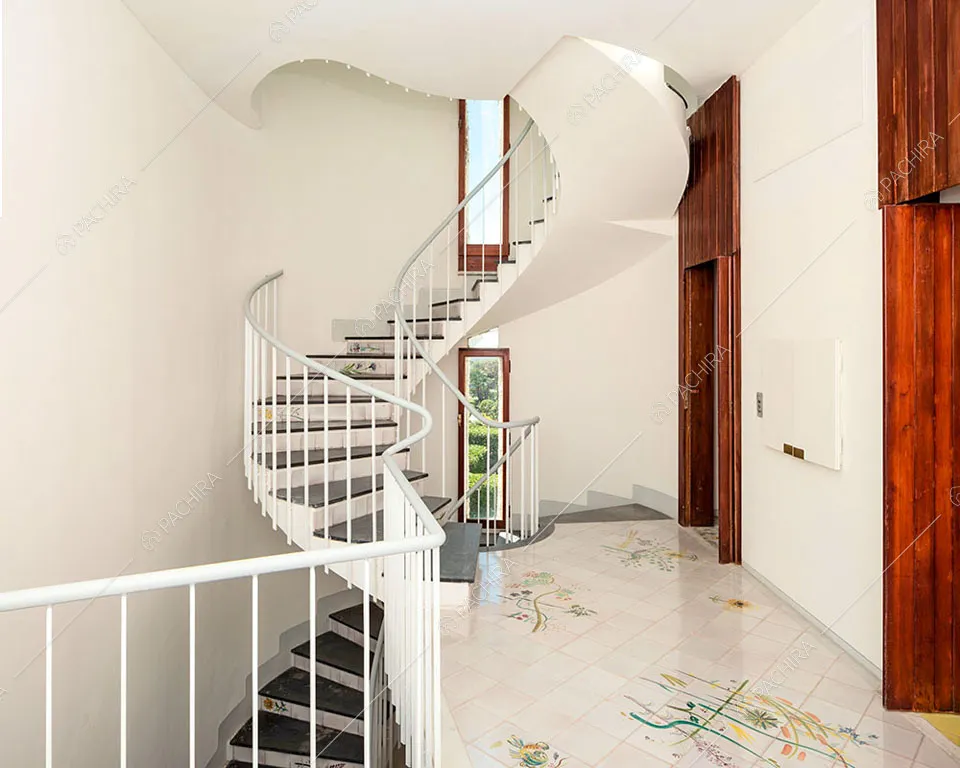 Scala a chiocciola bianca della villa Libeccio, location in stile moderno a Roma