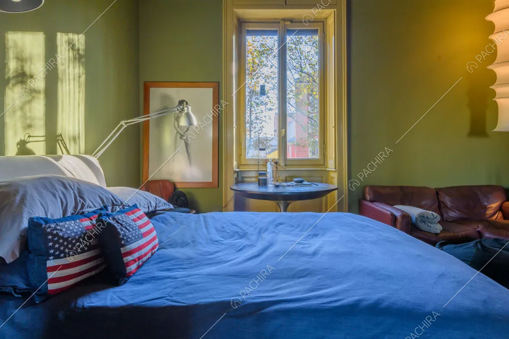 Pareti verdi della camera da letto matrimoniale dell'appartamento Garbino, location in stile classico a Milano