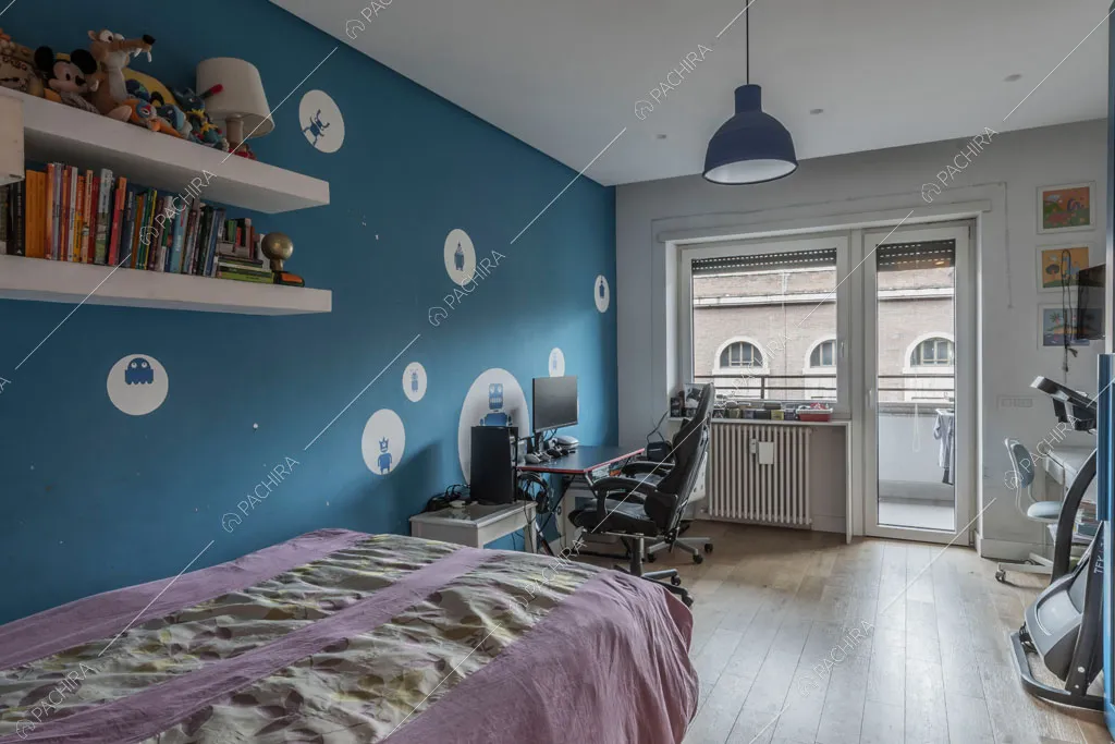 Camera da letto con parete blu dell'appartamento Mate, location in stile contemporaneo a Roma