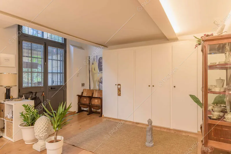 Pavimento in parquet, porta in stile industriale e armadio a muro bianco