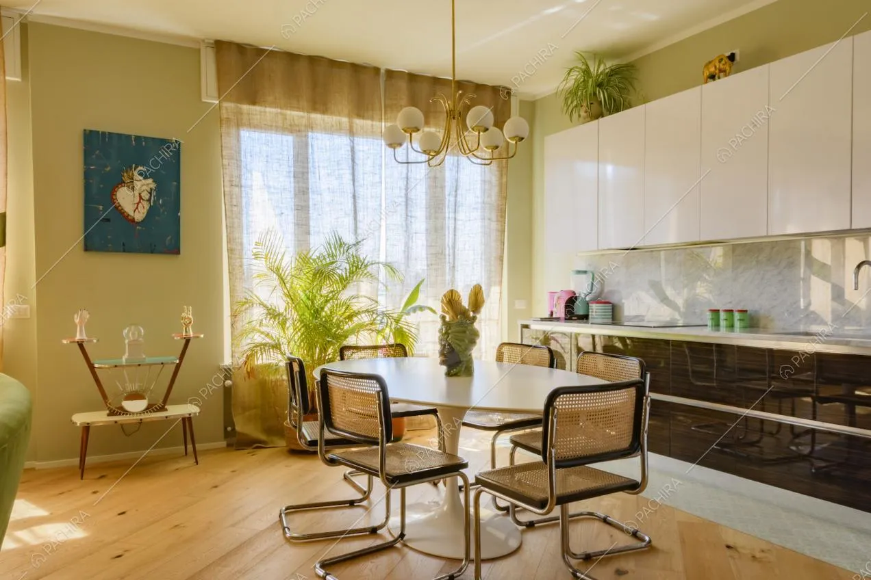 Zona pranzo con tavolo e cucina a parete moderna