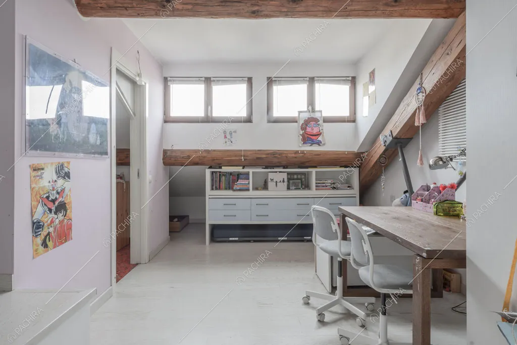 Camera con travi in legno a vista del loft Ostro, location in stile contemporaneo a Milano