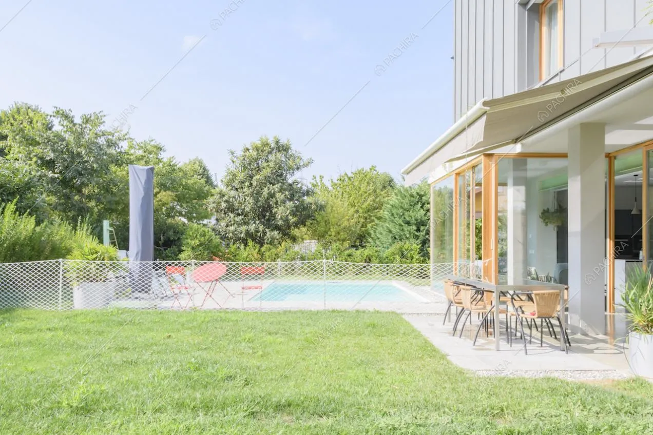 Veranda con tavolo da pranzo e vista sul giardino e sulla piscina