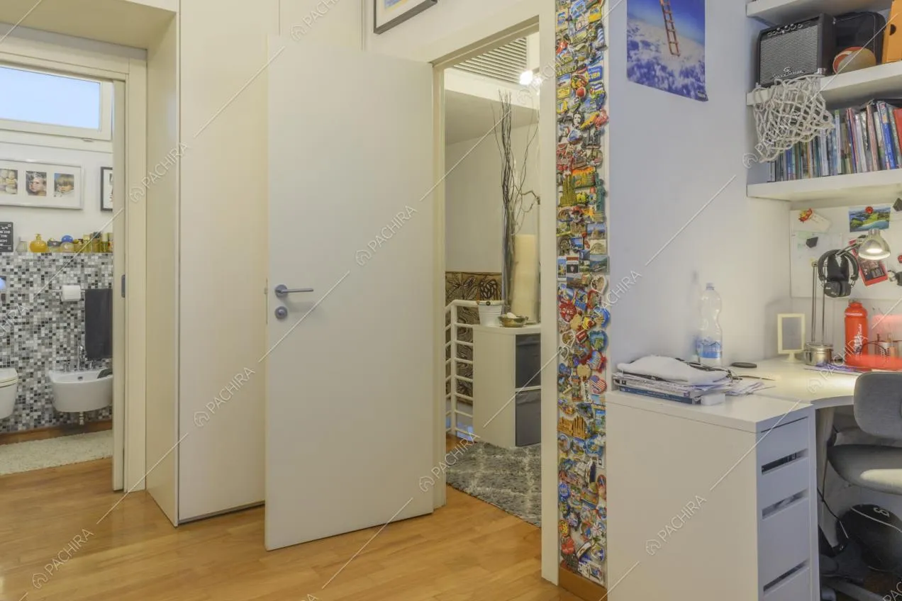 Studio con scrivania bianca e bagno privato