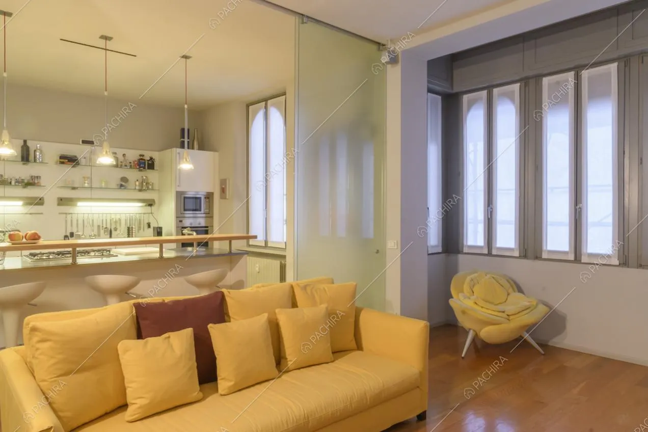 Soggiorno con divano giallo e bow-window
