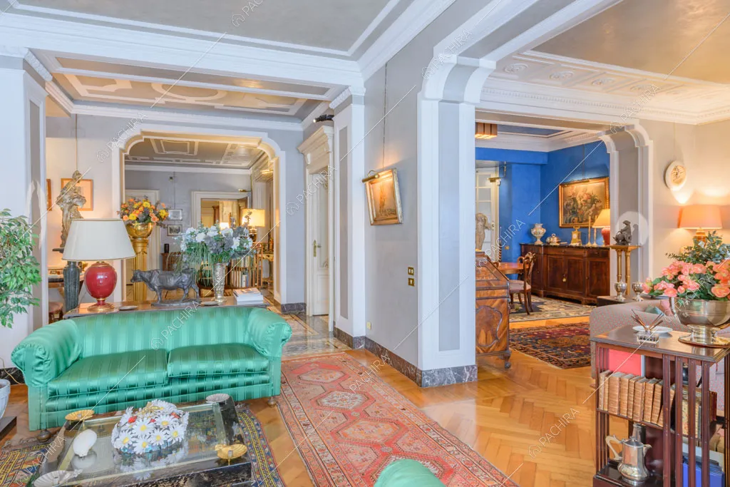 Luminosa zona living con boiserie dell'appartamento Agazzino, location in stile classico a Milano