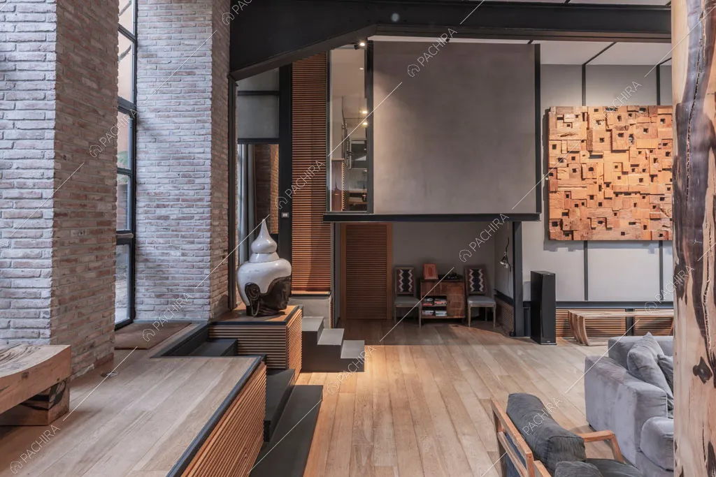 Pareti in mattoni a vista nella zona living del loft Berillio, location in stile contemporaneo a Roma