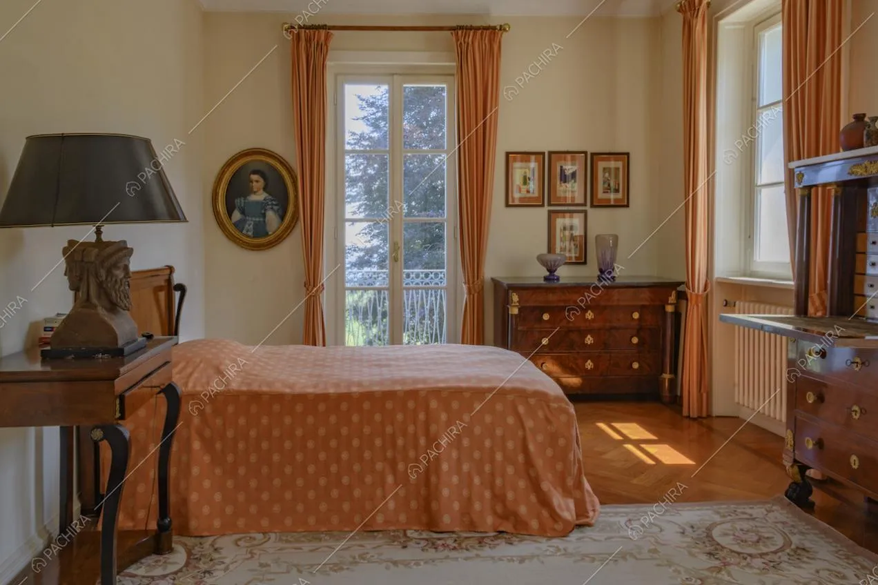 Camera da letto con mobili d'epoca e quadri appesi alle pareti