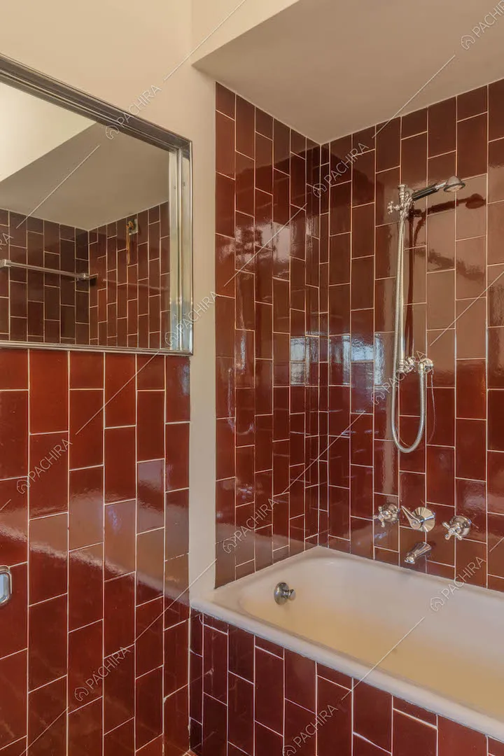 Vasca nel bagno con pareti e pavimento in piastrelle rosse