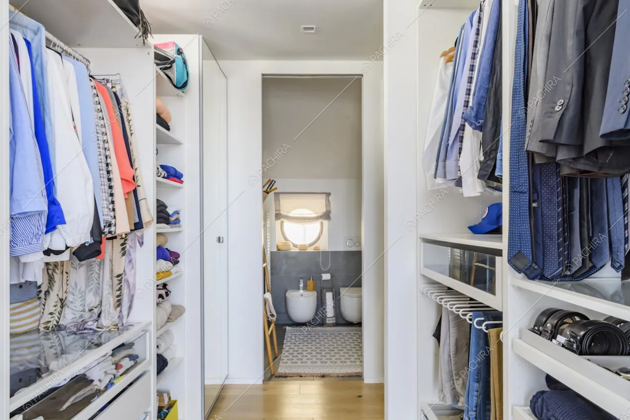 Ampia cabina armadio con pavimento in parquet porta al bagno privato