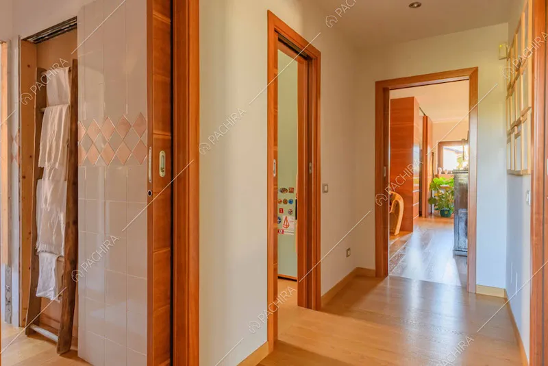 Corridoio con pavimento in parquet e vista sulla camera da letto