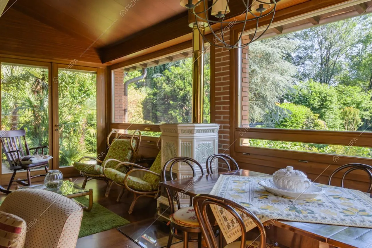 Sedia a dondolo antica e vetrate con vista sul giardino